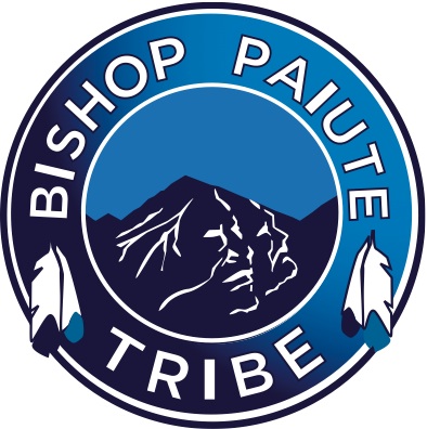 Picture of a circle icon that has mountains outlined like peoples faces and feathers around the circle. It says:
BISHOP PAIUTE TRIBE